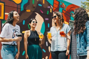 A group of friends is hanging out outside and socializing after moving to a new city.